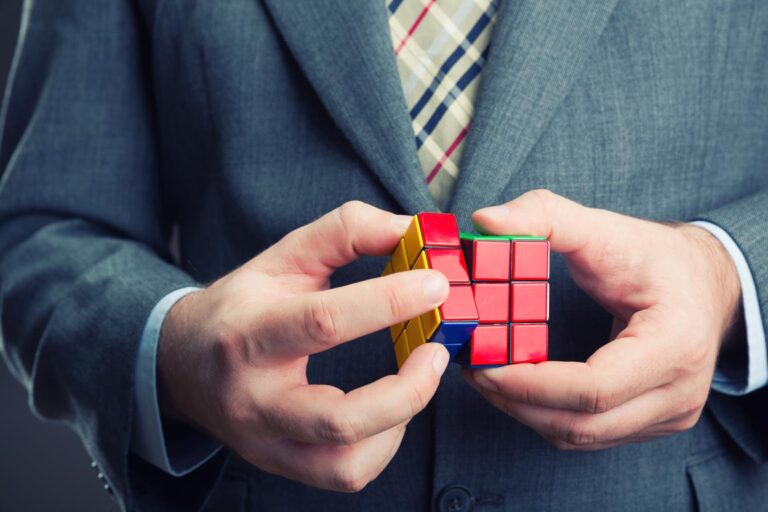 businessman holding rubik cube his hands